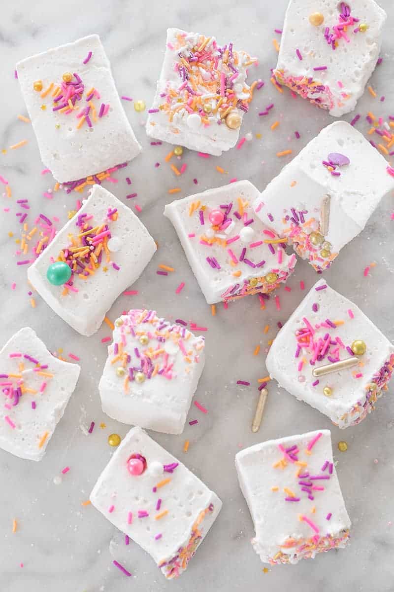 Marshmallow recipe with sprinkles on a marble table.