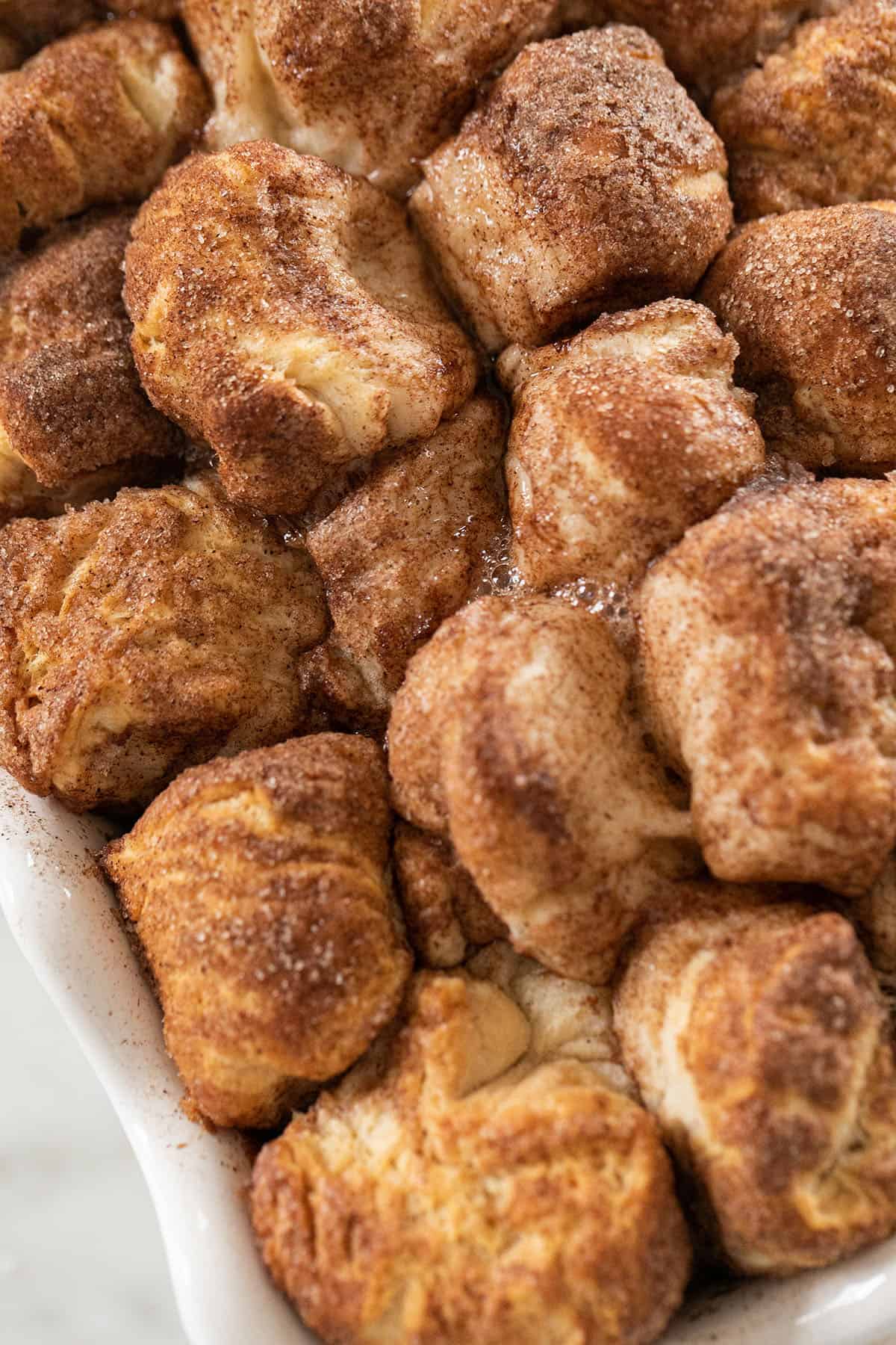 Golden brown monkey bread with gooey butter and cinnamon and sugar.