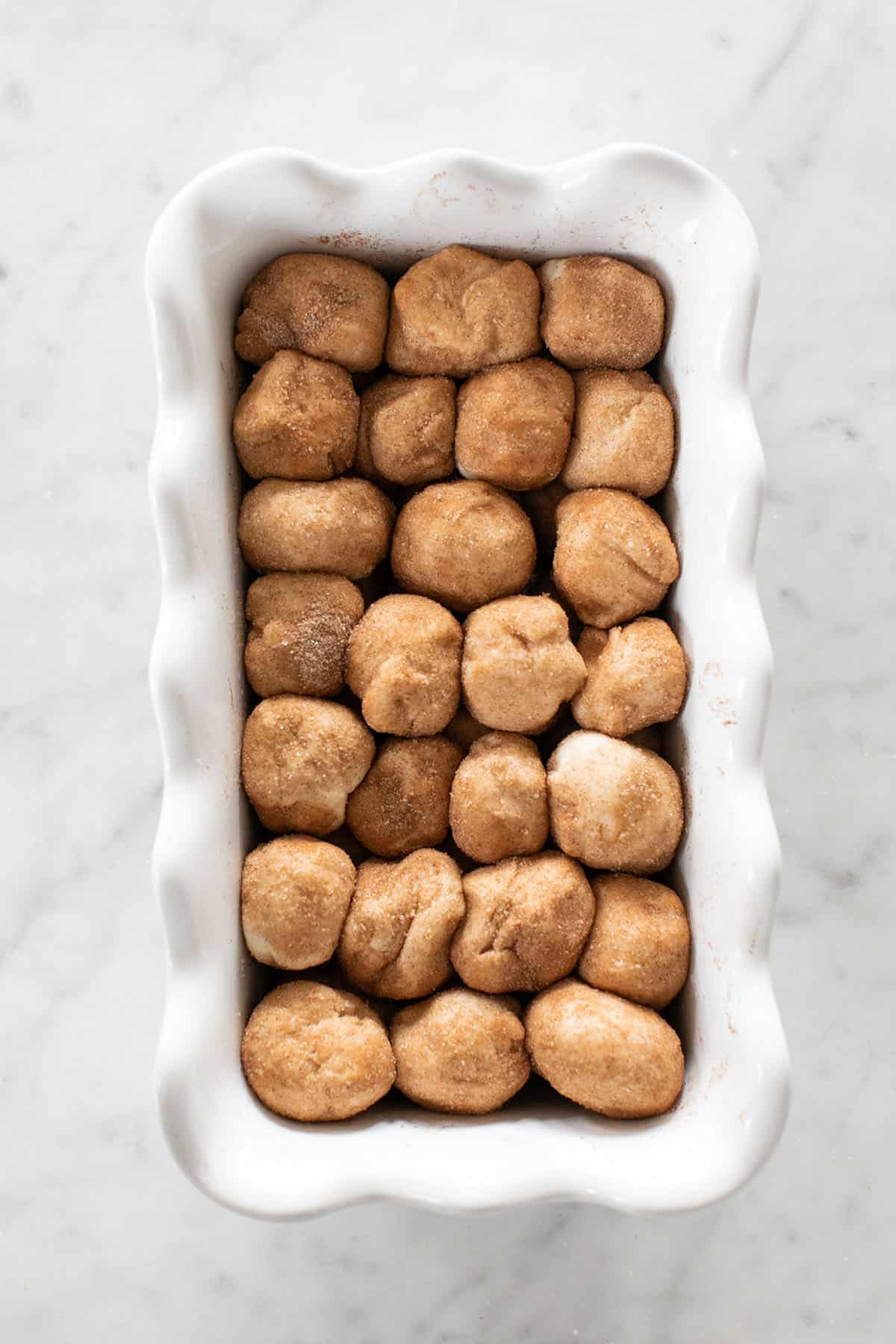 balls of dough rolled in cinnamon and sugar  to make an easy monkey bread recipe.
