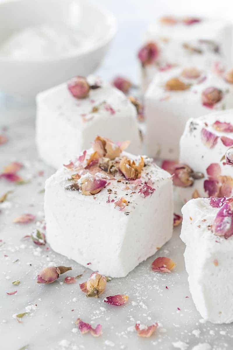 Large, fluffy white marshmallow with dried rose petals over the top.