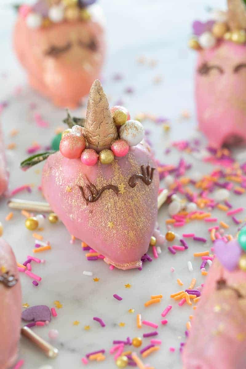 Strawberry unicorns dipped in pink candy melts and gold glitter