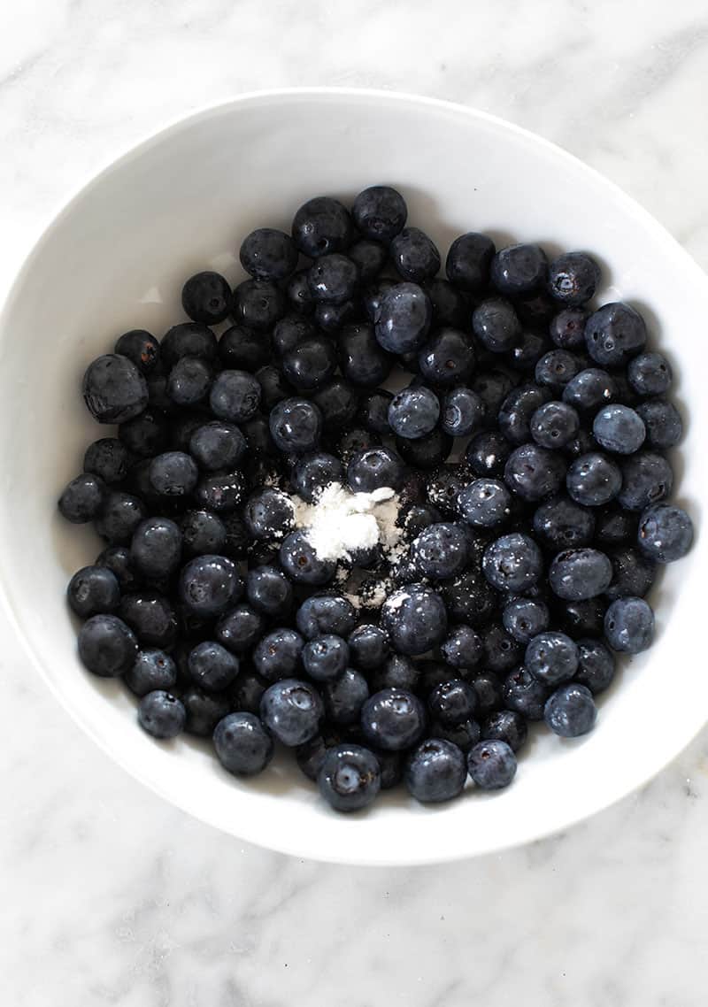 Blueberries with cornstarch in a white bowl. 
