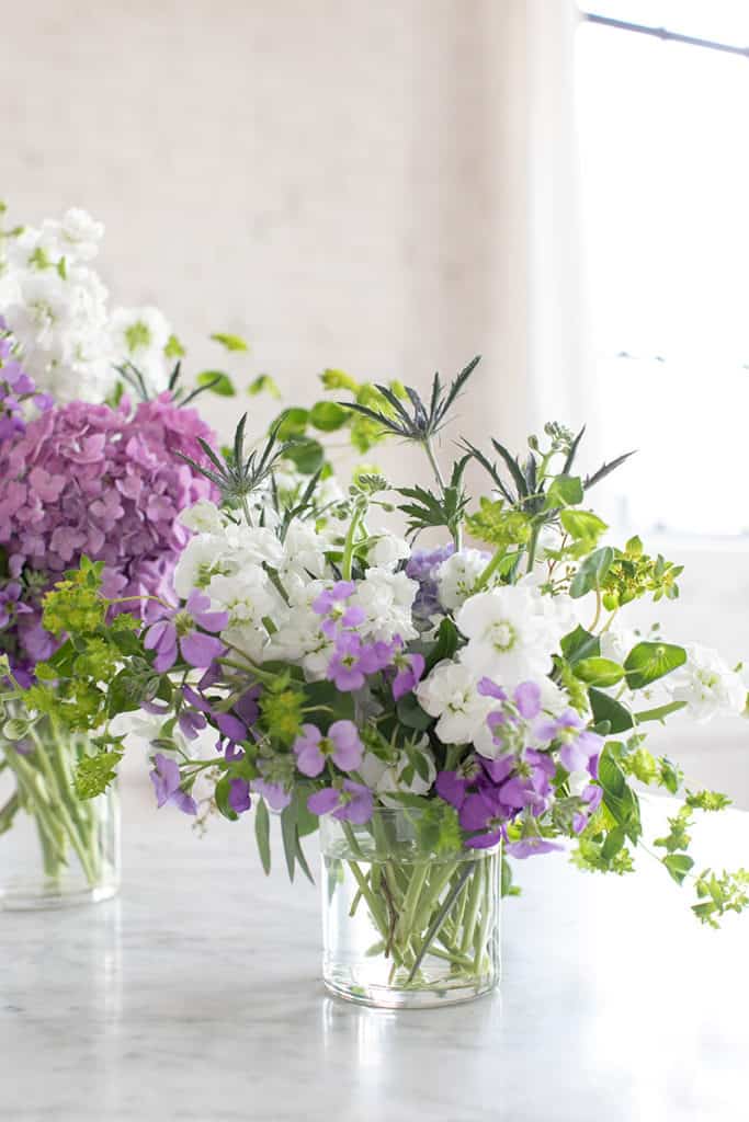 Flower arrangements in clear class jars.