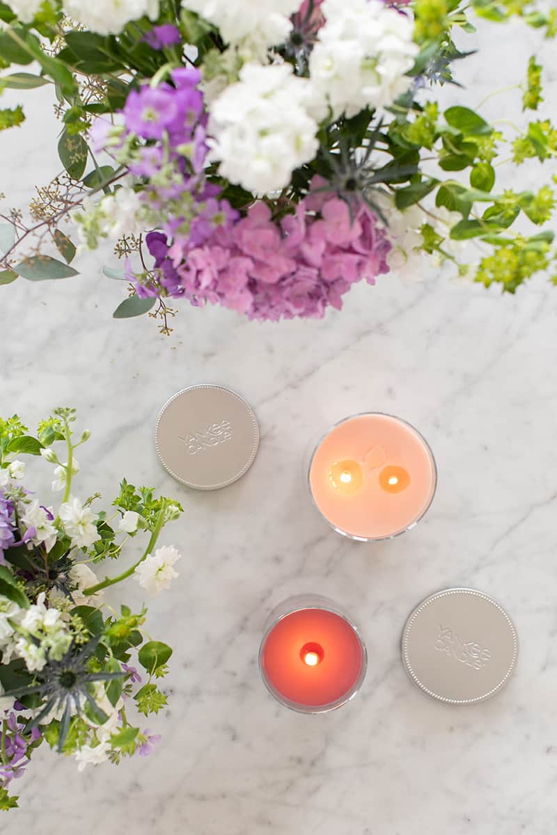 Flowers and candles on a marble table.