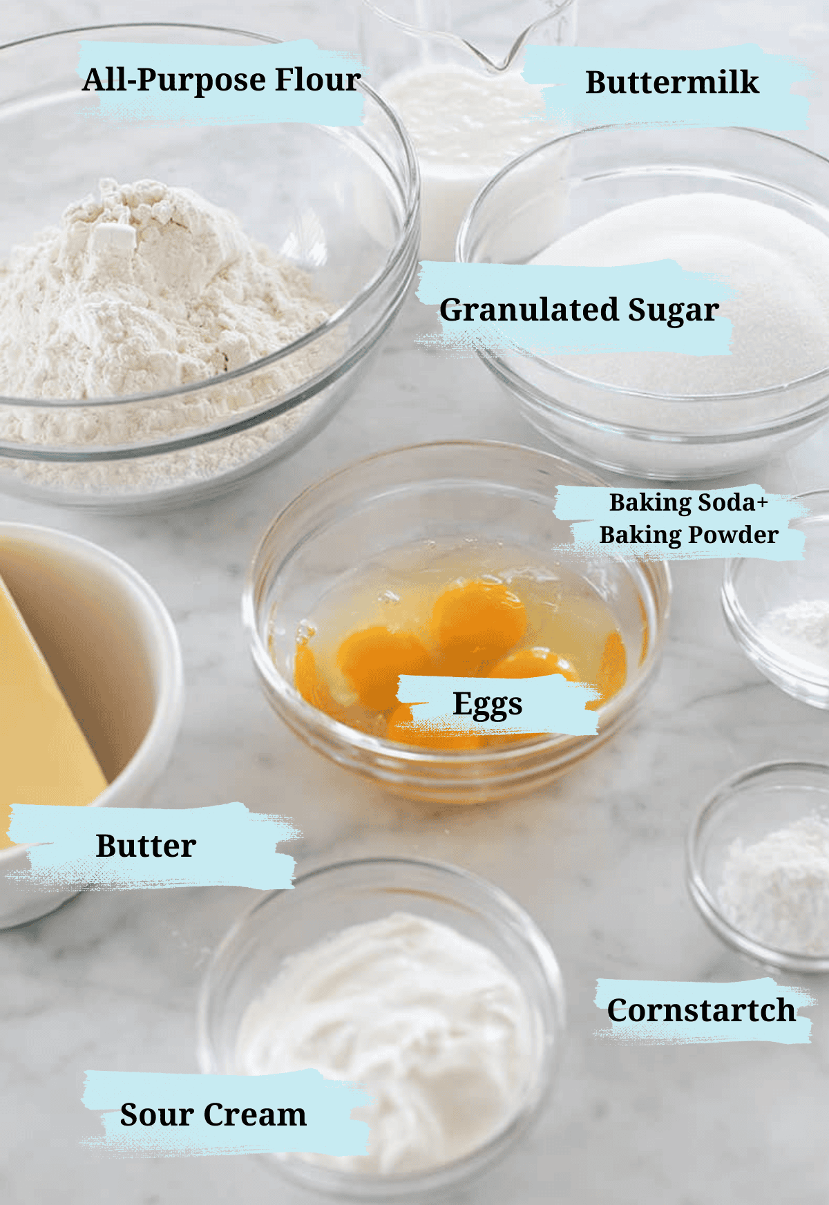 Ingredients in bowls to make a homemade birthday cake.