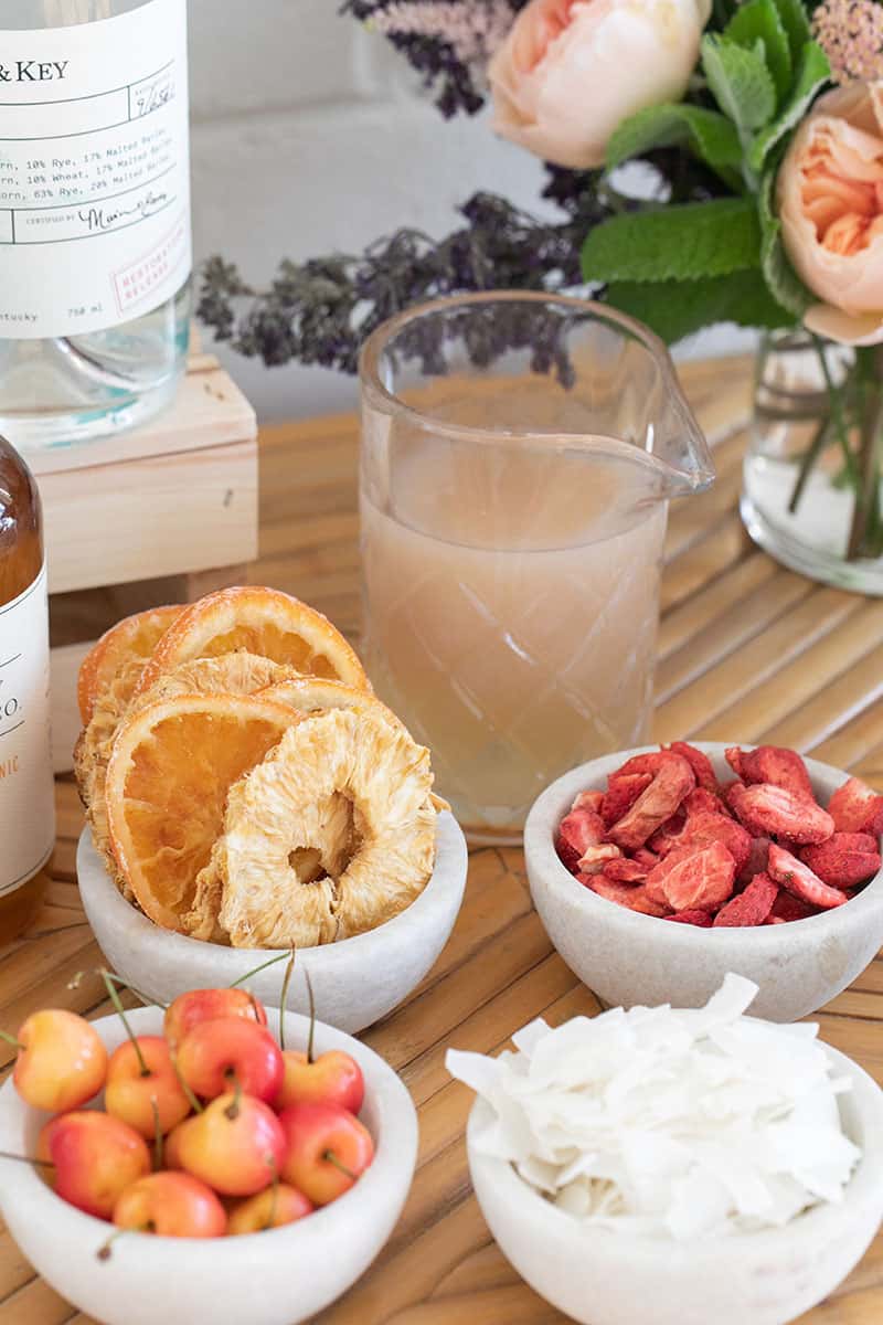 Ingredients in marble bowls on a cocktail snow cone bar.