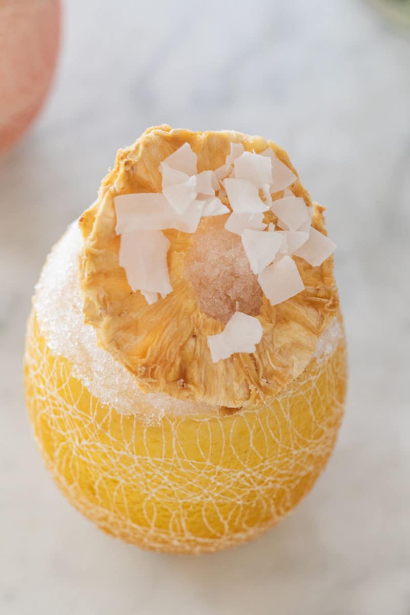 Yellow shaved ice with pineapple and coconut.