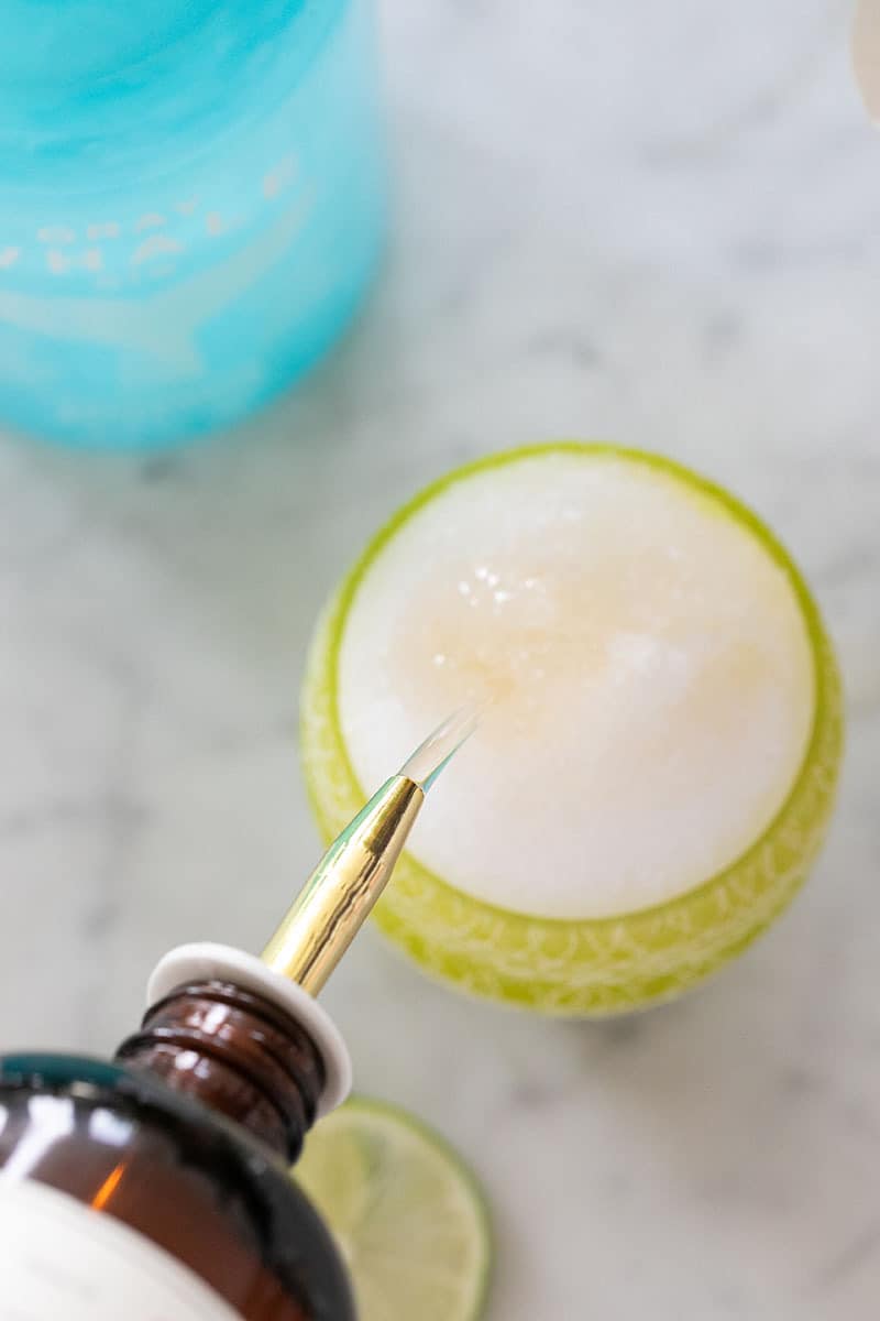 Pouring cocktail syrup over a snow cone.