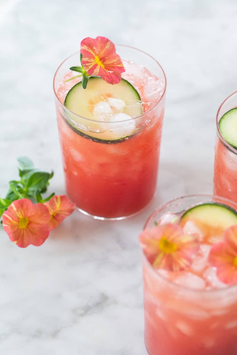 Pink drink made with watermelon and cucumber in a pretty glass on the table.