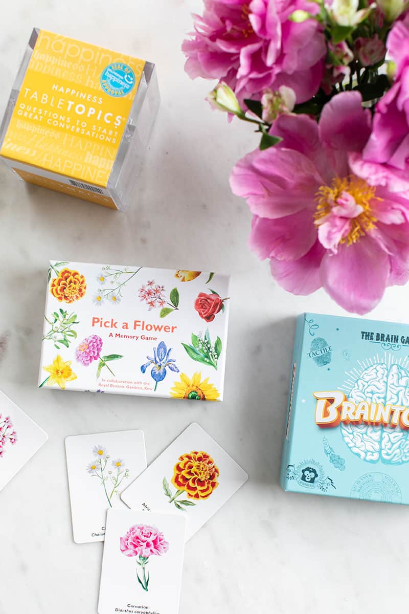 Games on a marble table with pink flowers.