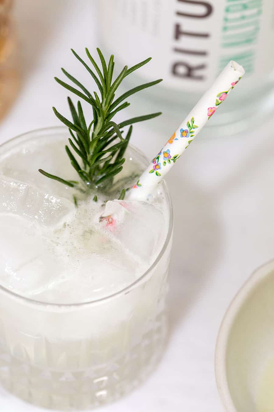 Mocktail cocktail with a floral straw.