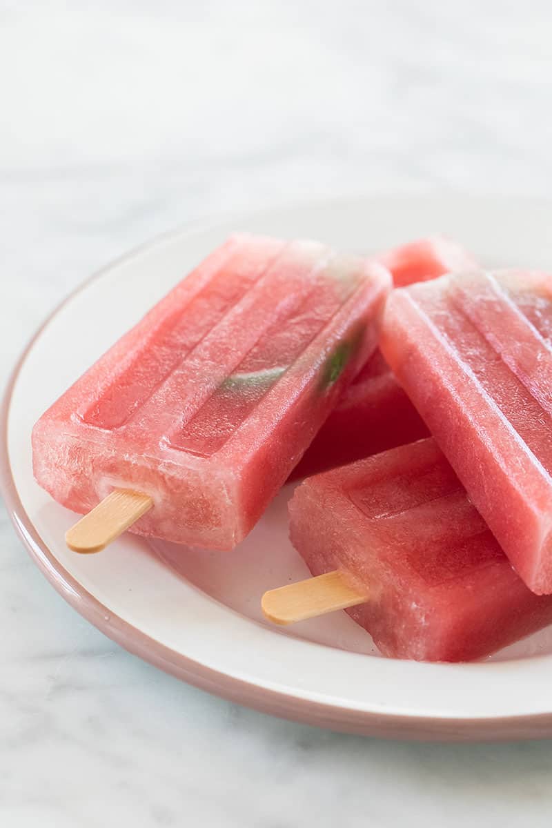 watermelon popsicles on a plate.