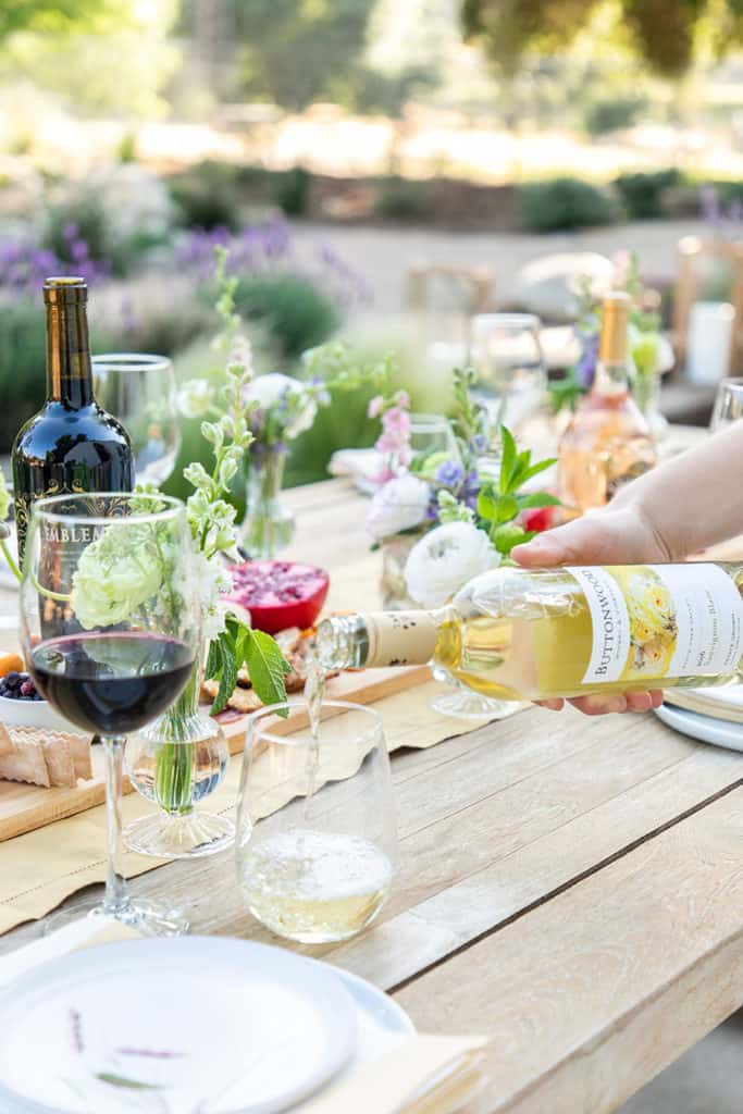 Pouring wine in a wine glass for dining alfresco.