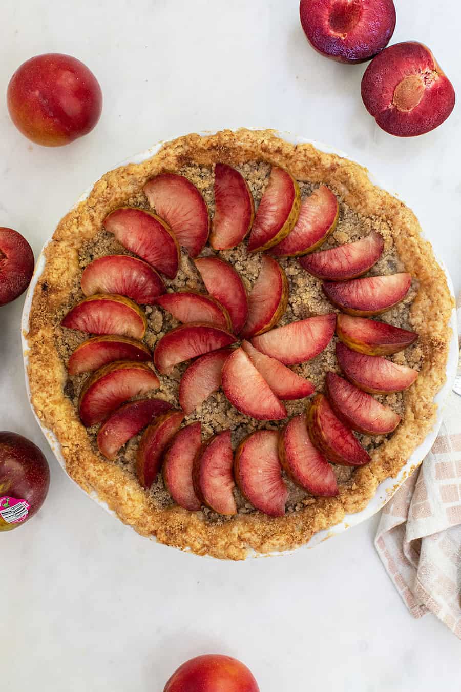 Whole pie with crumble top and slice plumcots