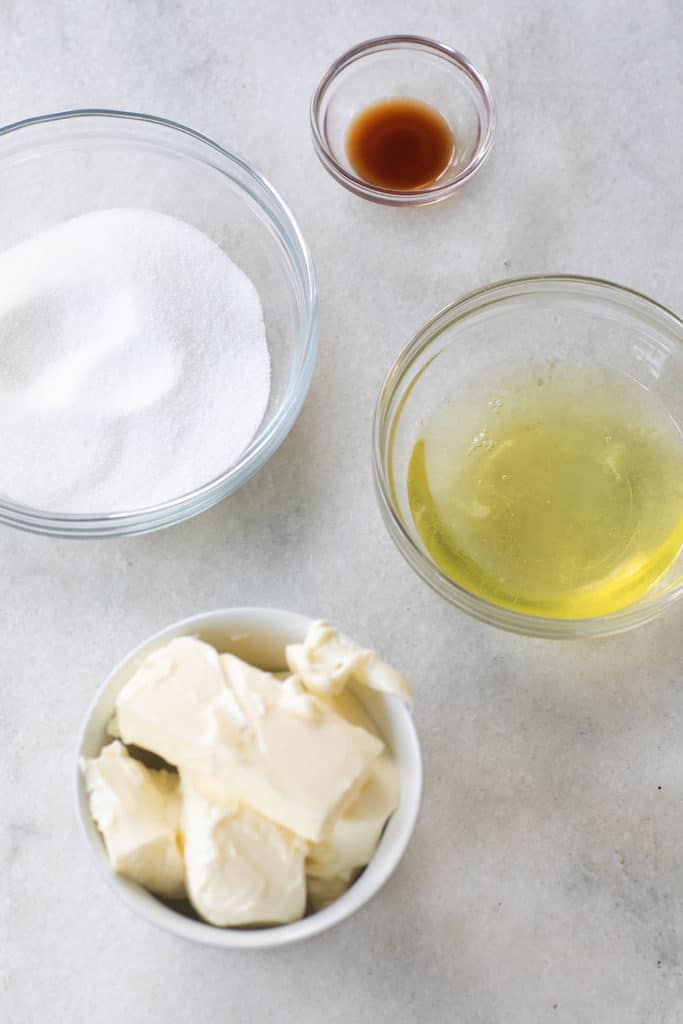 
sugar, egg whites, butter and vanilla in glass bowls. 