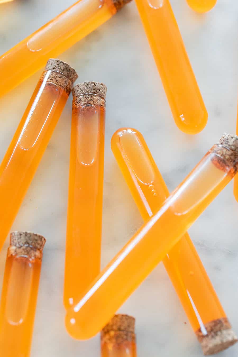 Candy corn vodka in test tubes.