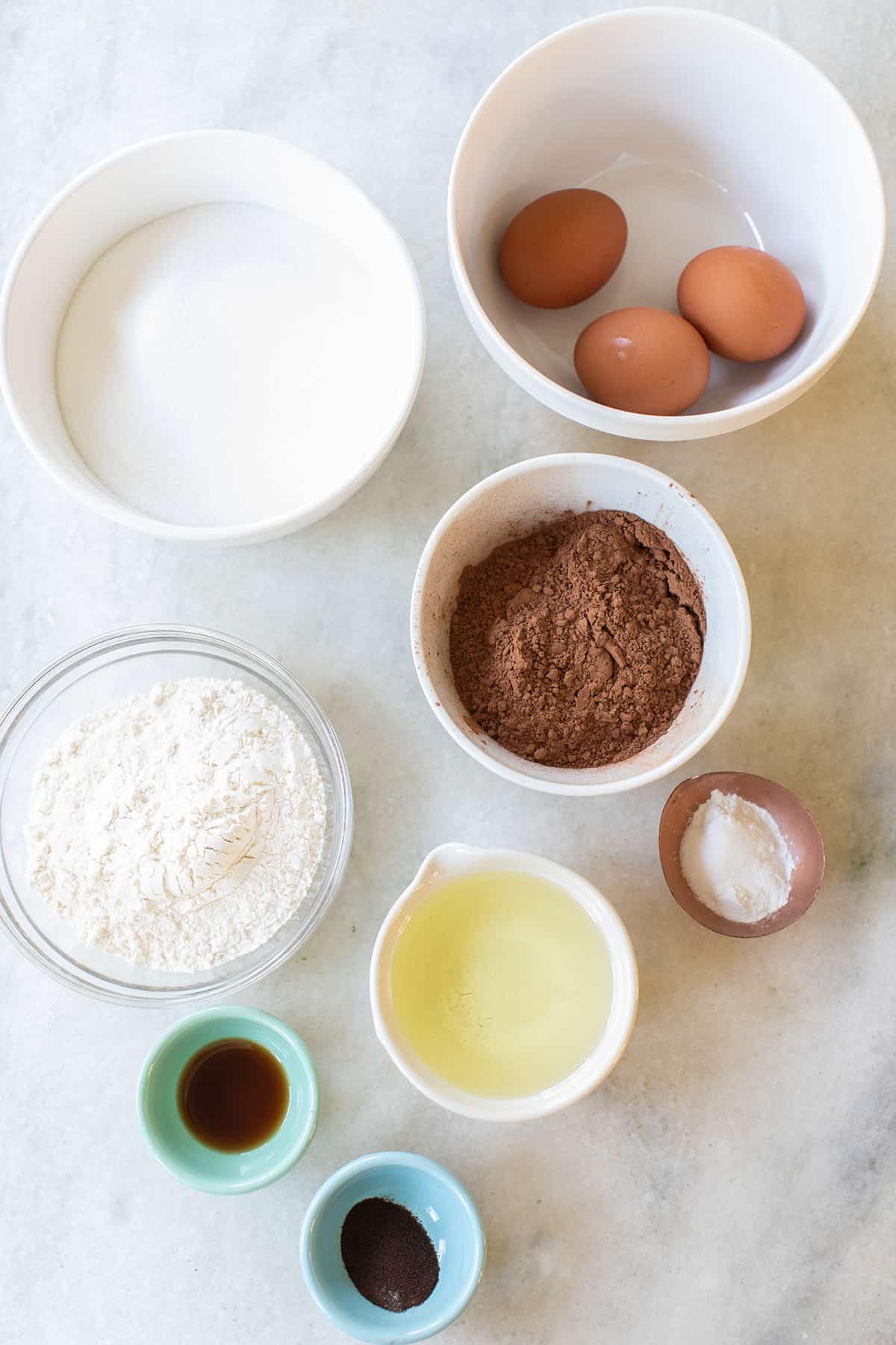 ingredients in bowls to make chocolate crinkle cookies
