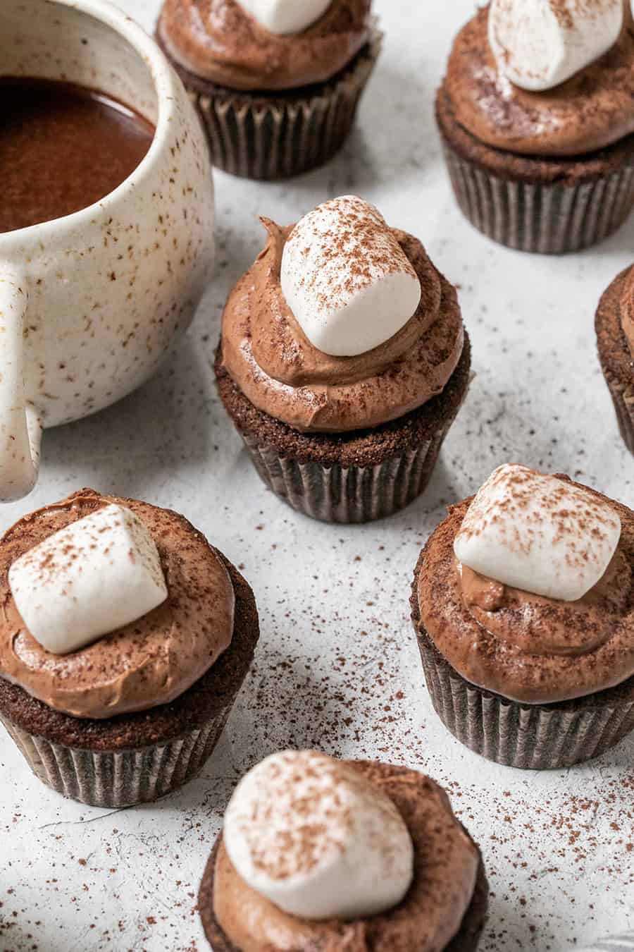 Hot Chocolate Cupcakes topped with marshmallows and sprinkled with hot chocolate.