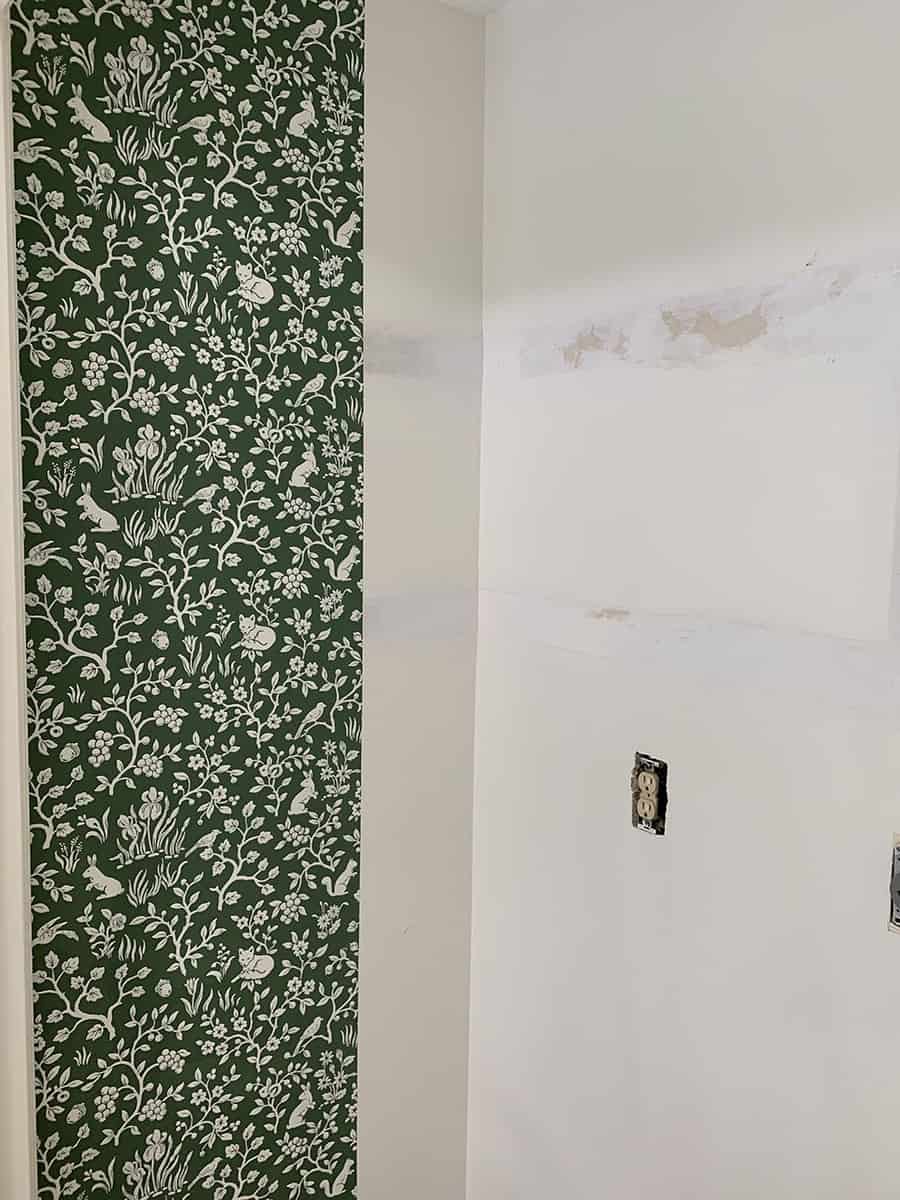 Hanging wallpaper in a laundry closet.