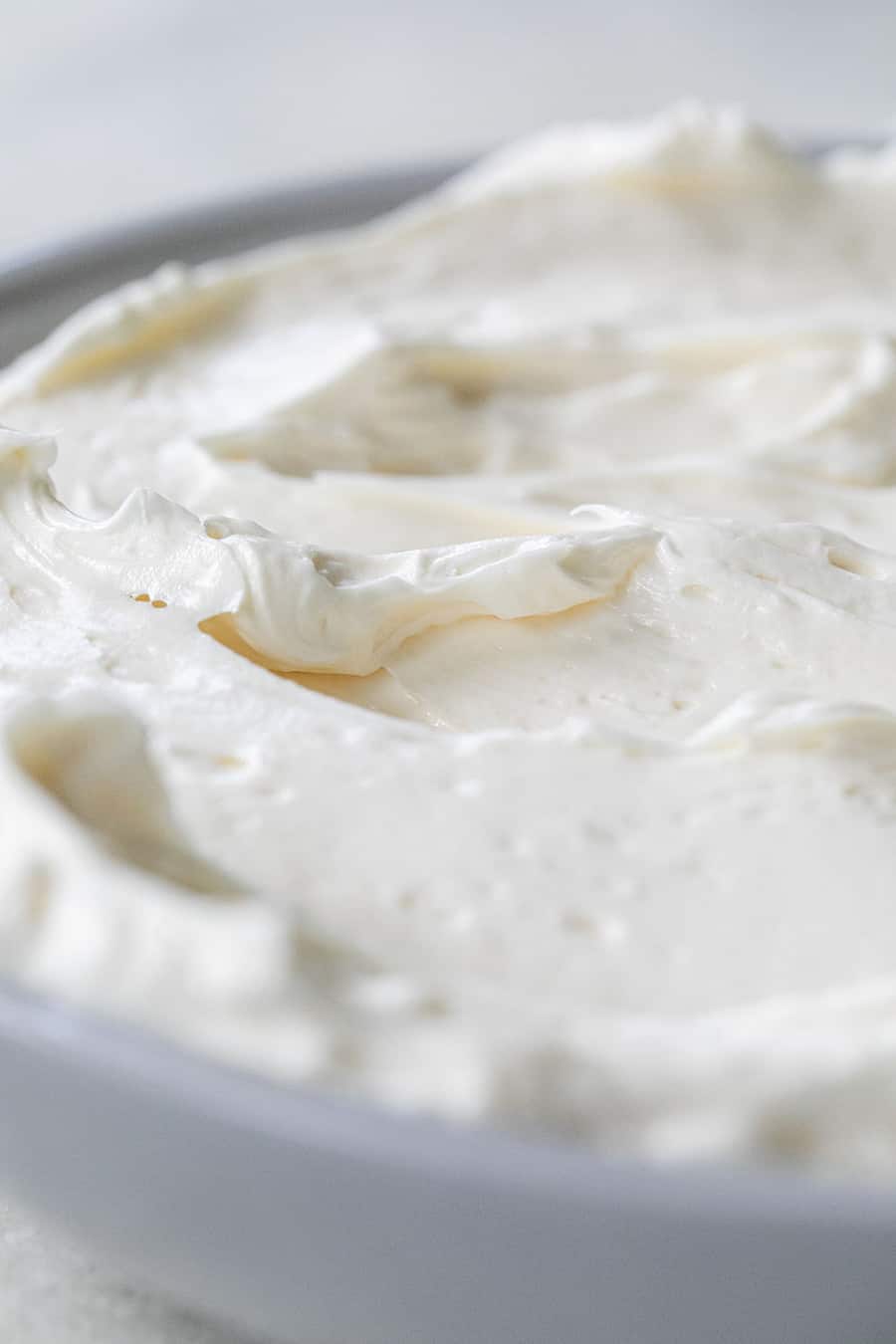 Swiss meringue buttercream in a gray bowl.