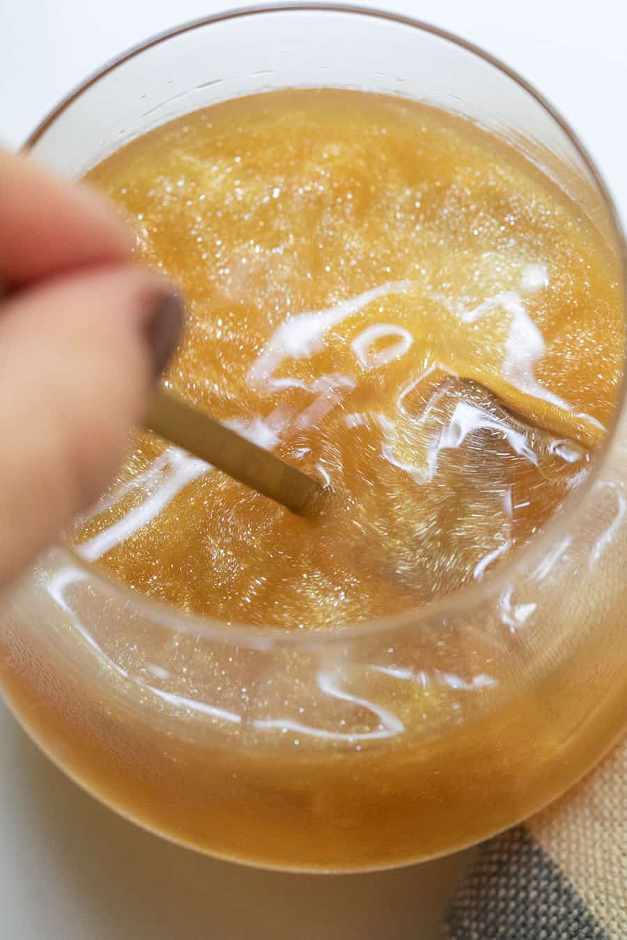 Stirring a cocktail with shimmer in it - halloween drink