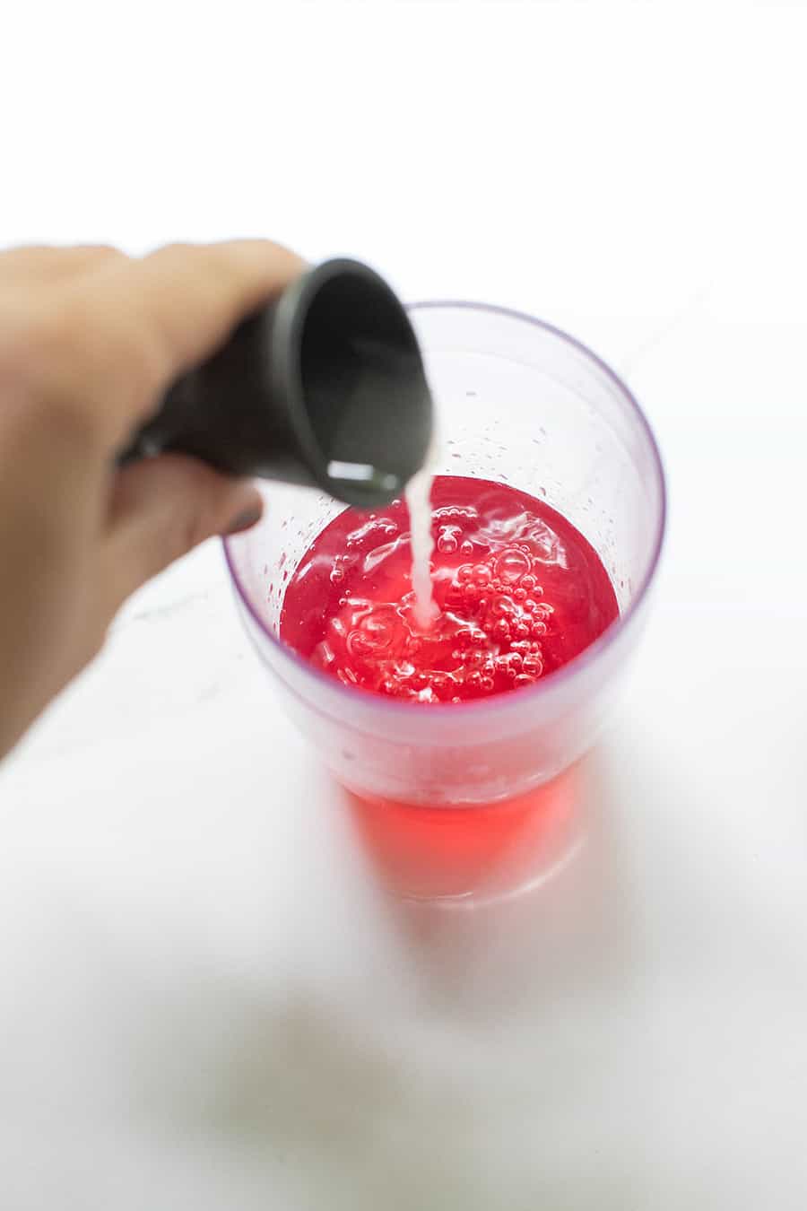 lime juice, cranberry juice in a cocktail shaker  - orange peel, cosmopolitan cocktails