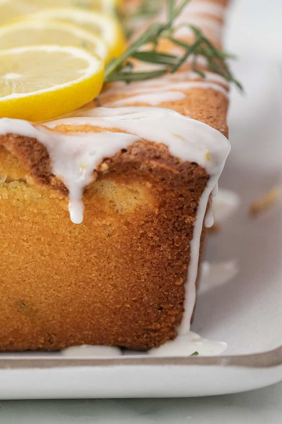 Lemon loaf cake with a drizzled glaze over the top.