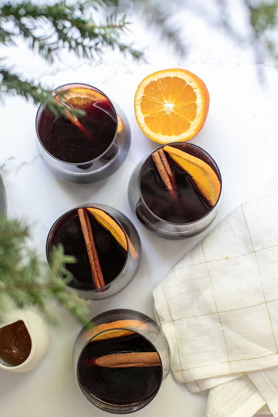 mulled wine recipe in glasses with orange class and cinnamon sticks