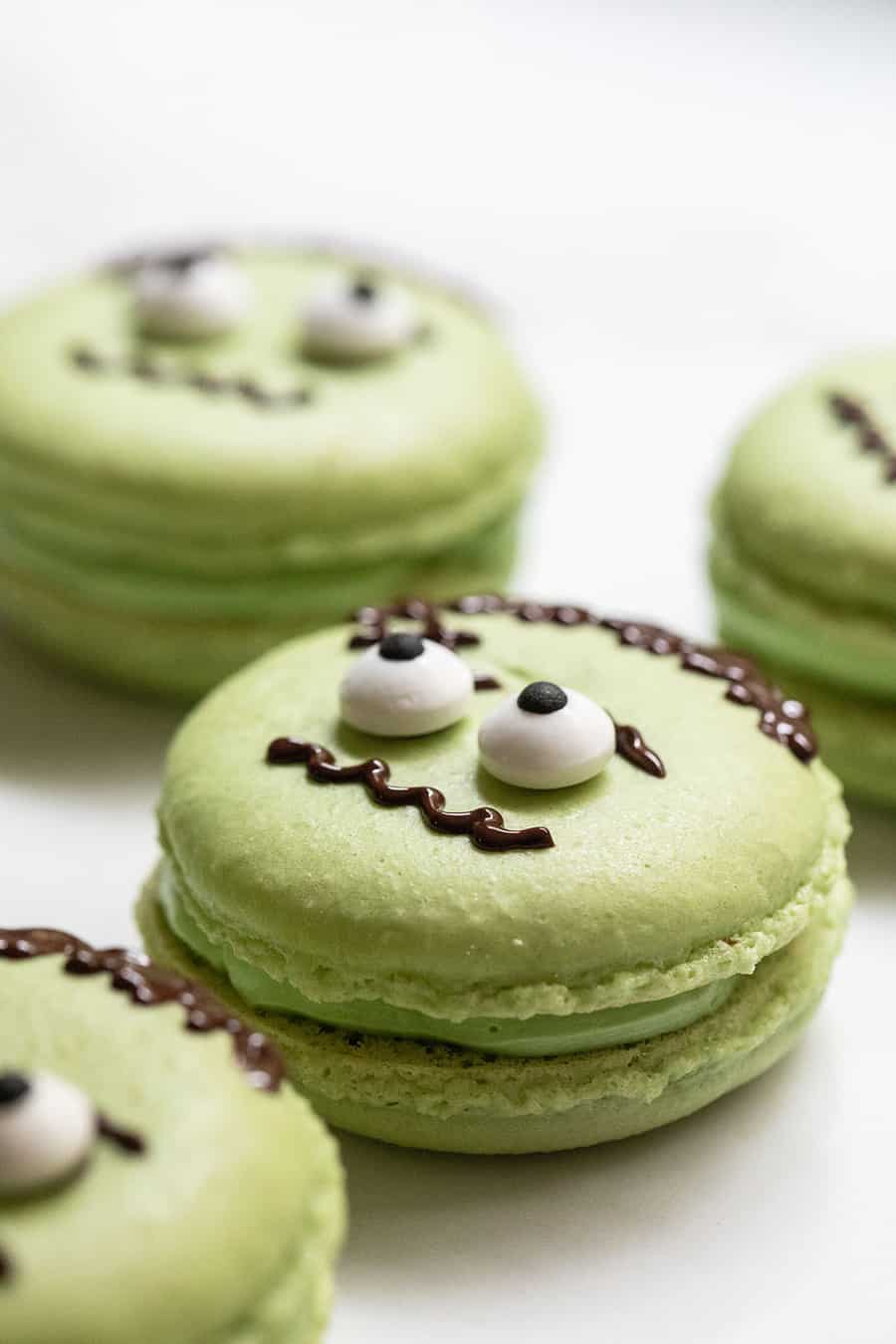 Green Frankenstein Macarons with eyes and chocolate face design. 
