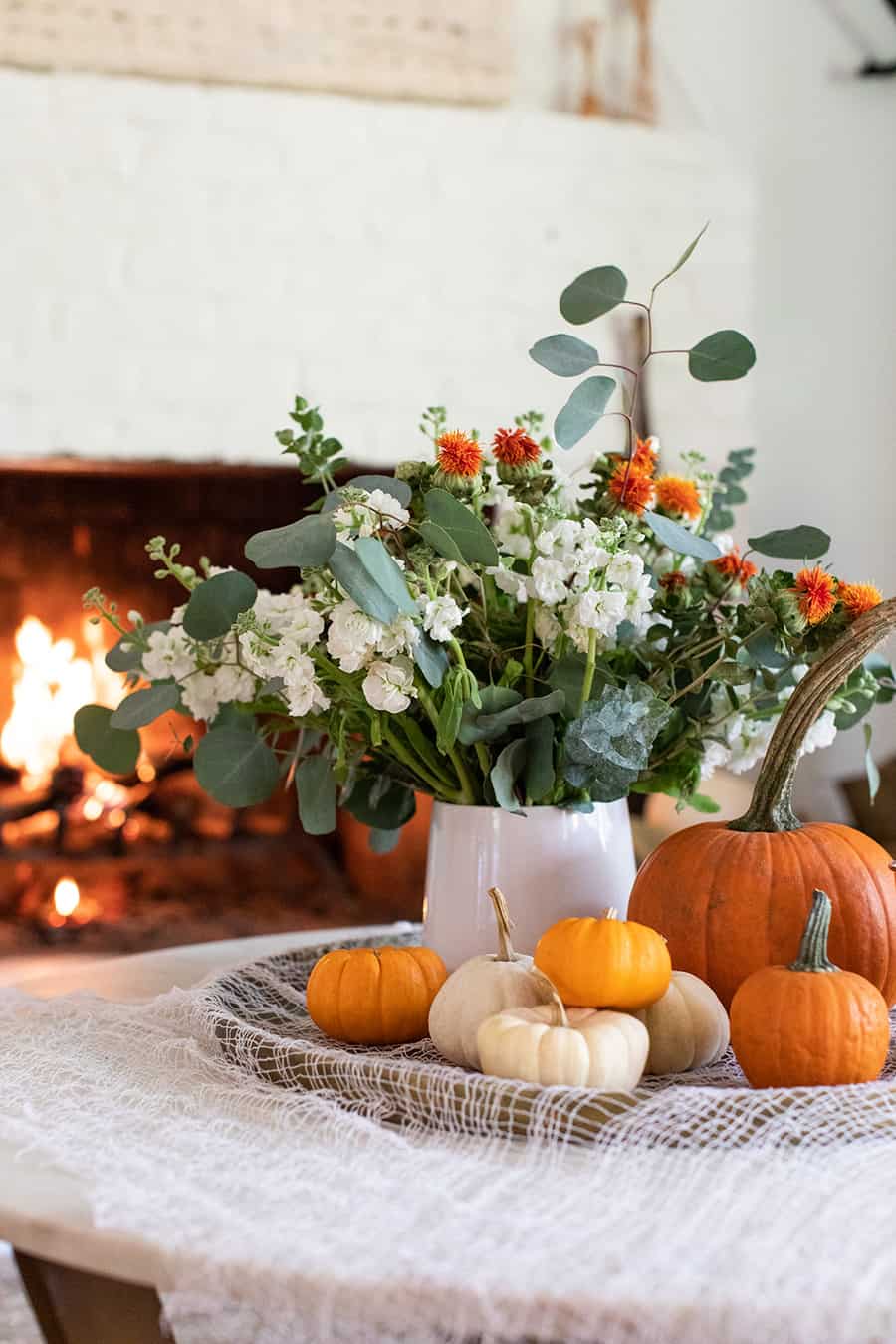 Halloween pumpkins and a vase wirth flowers 