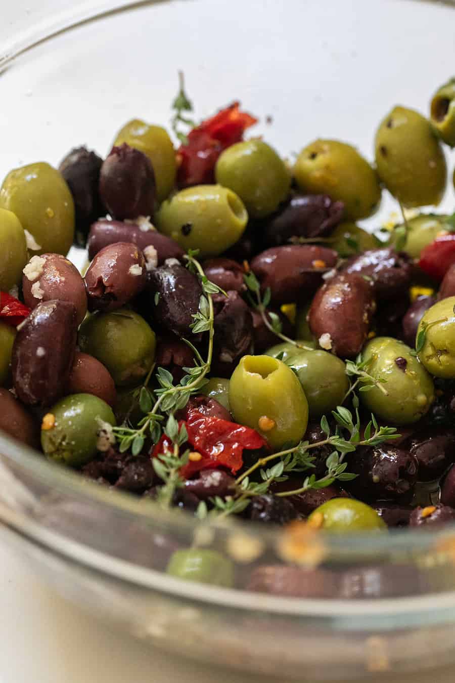 Marinated olives in a bowl with thyme