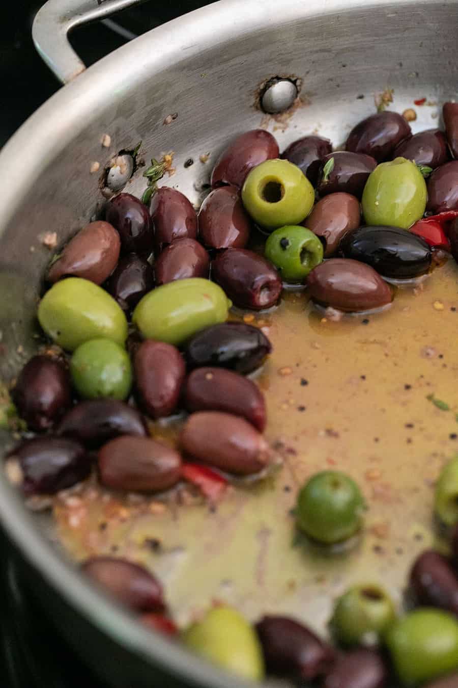 Marinated olives in a skillet 