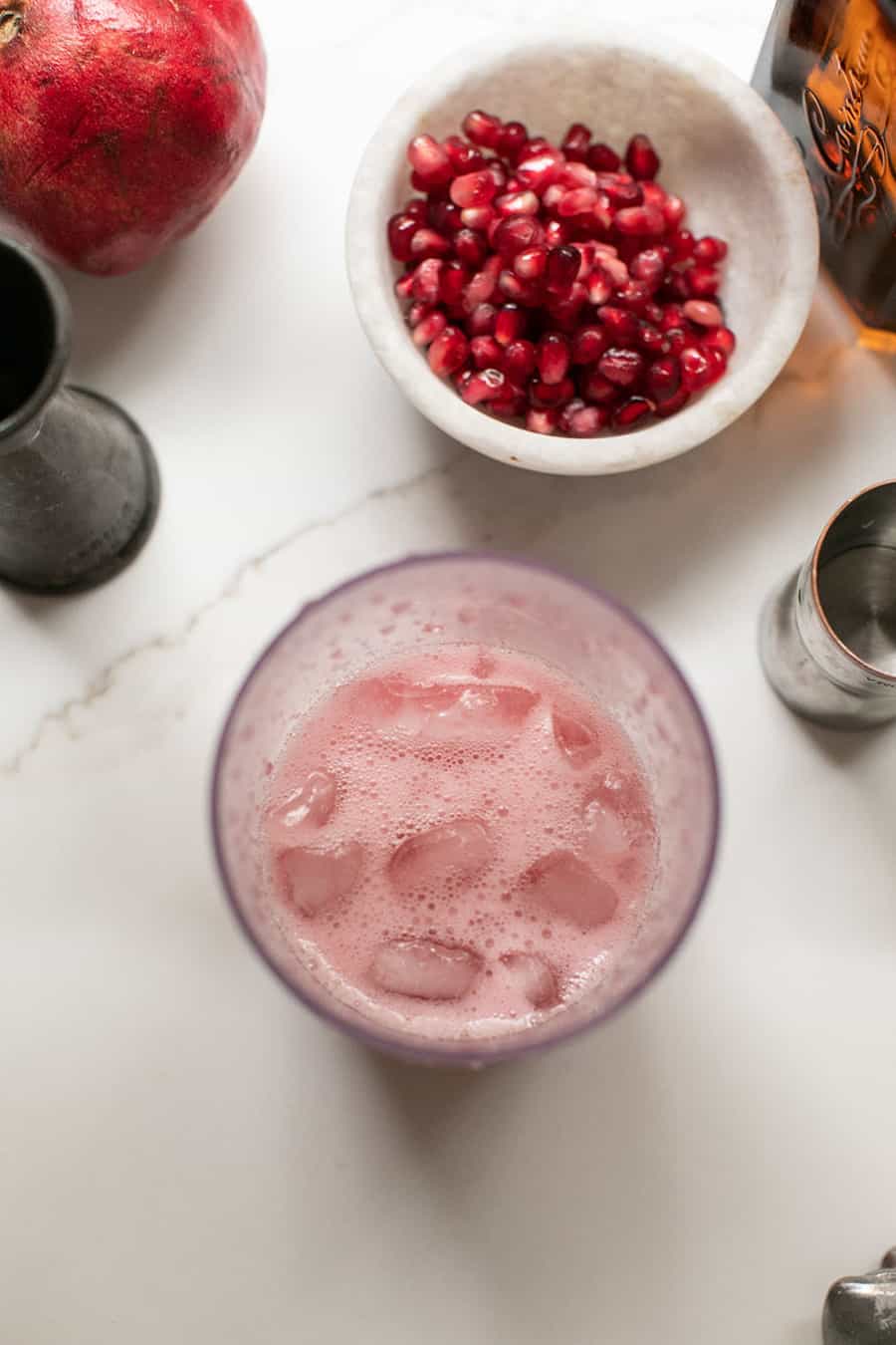 Fresh pomegranate cocktail in a cocktail shaker. 