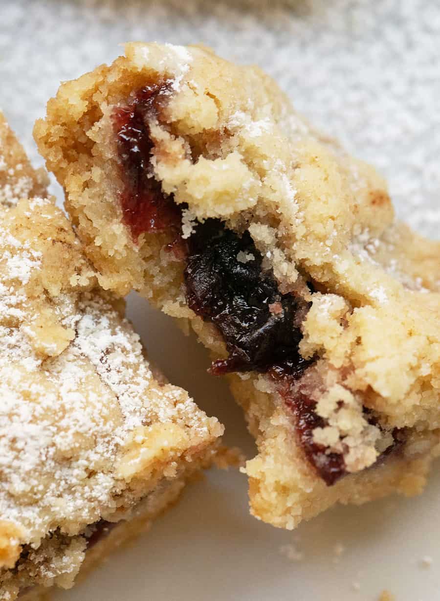 Crumble bar filled with raspberry preserves.