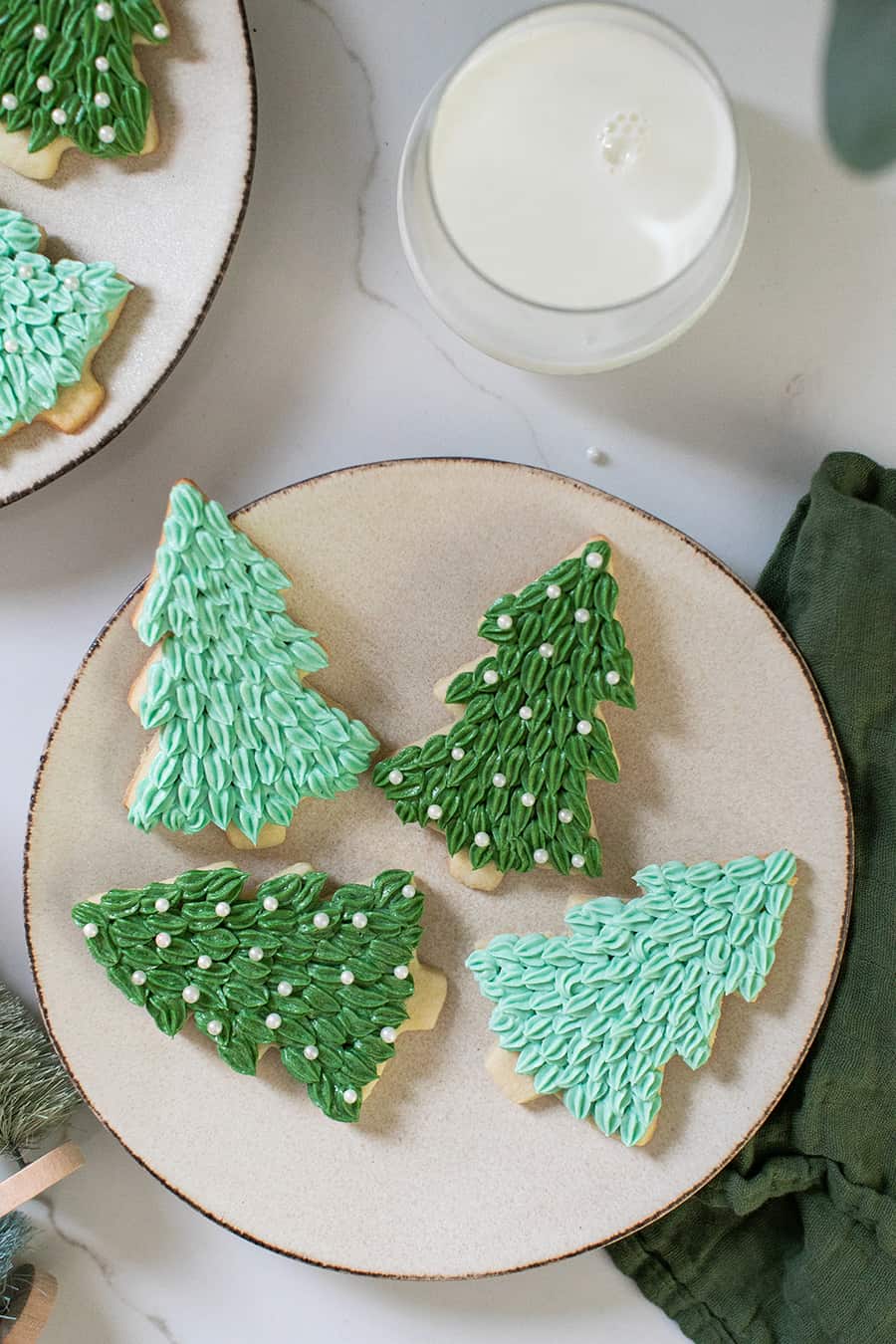 Tree Christmas sugar cookies, with green frosting and sprinkles.