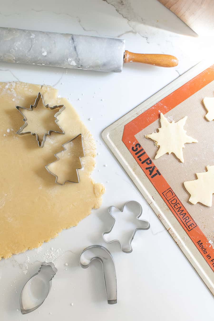 Rolling out Christmas sugar cookies.