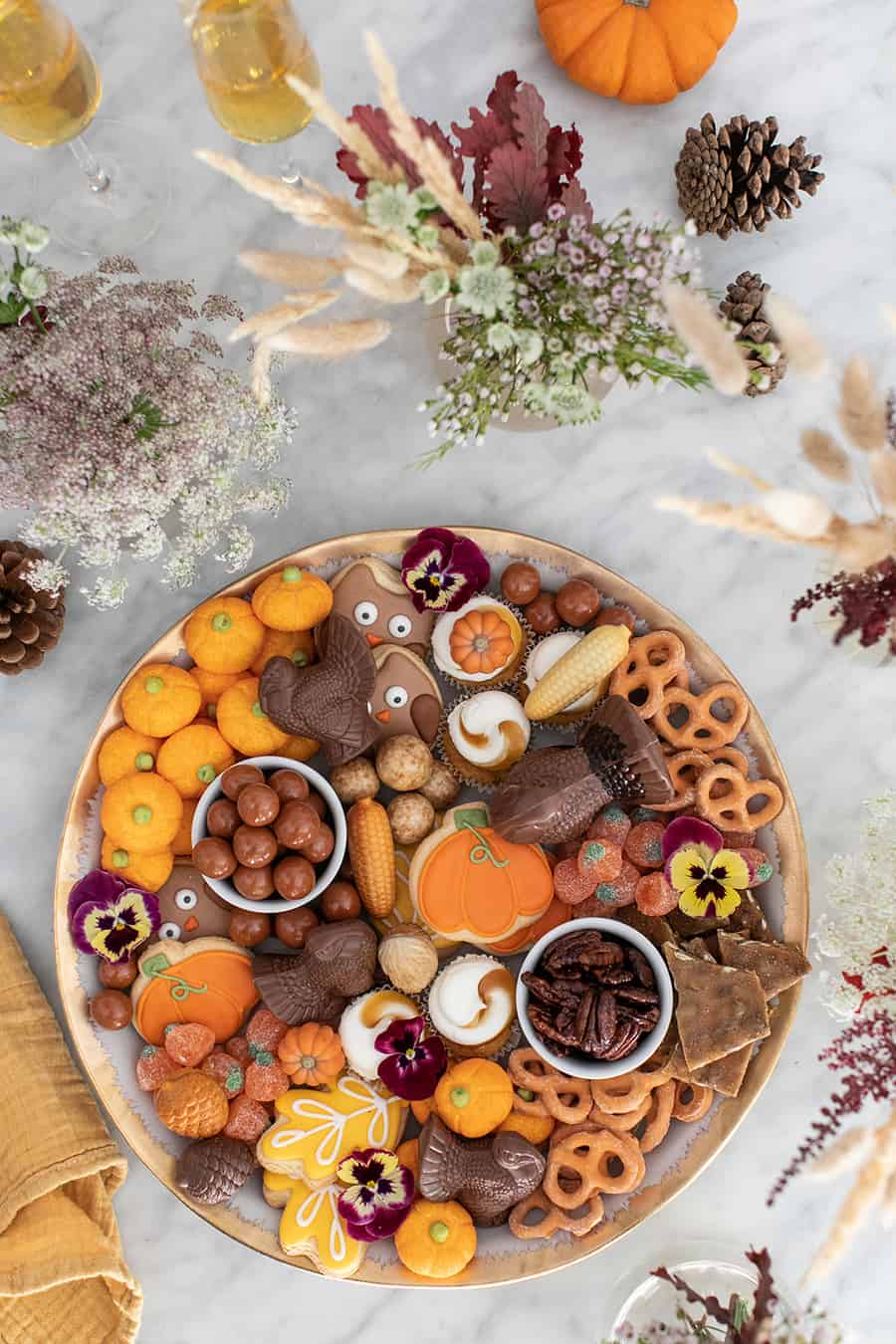 Thanksgiving dessert platter filled with fall cookies, cupcakes and candy.