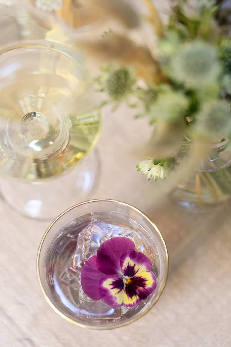 Water glass with a purple pansies 