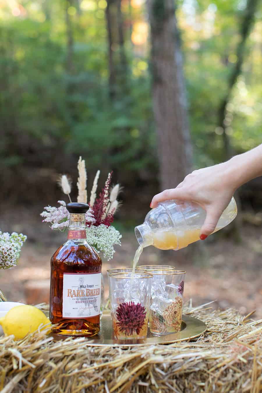 Pouring a Thanksgiving cocktail into a glass