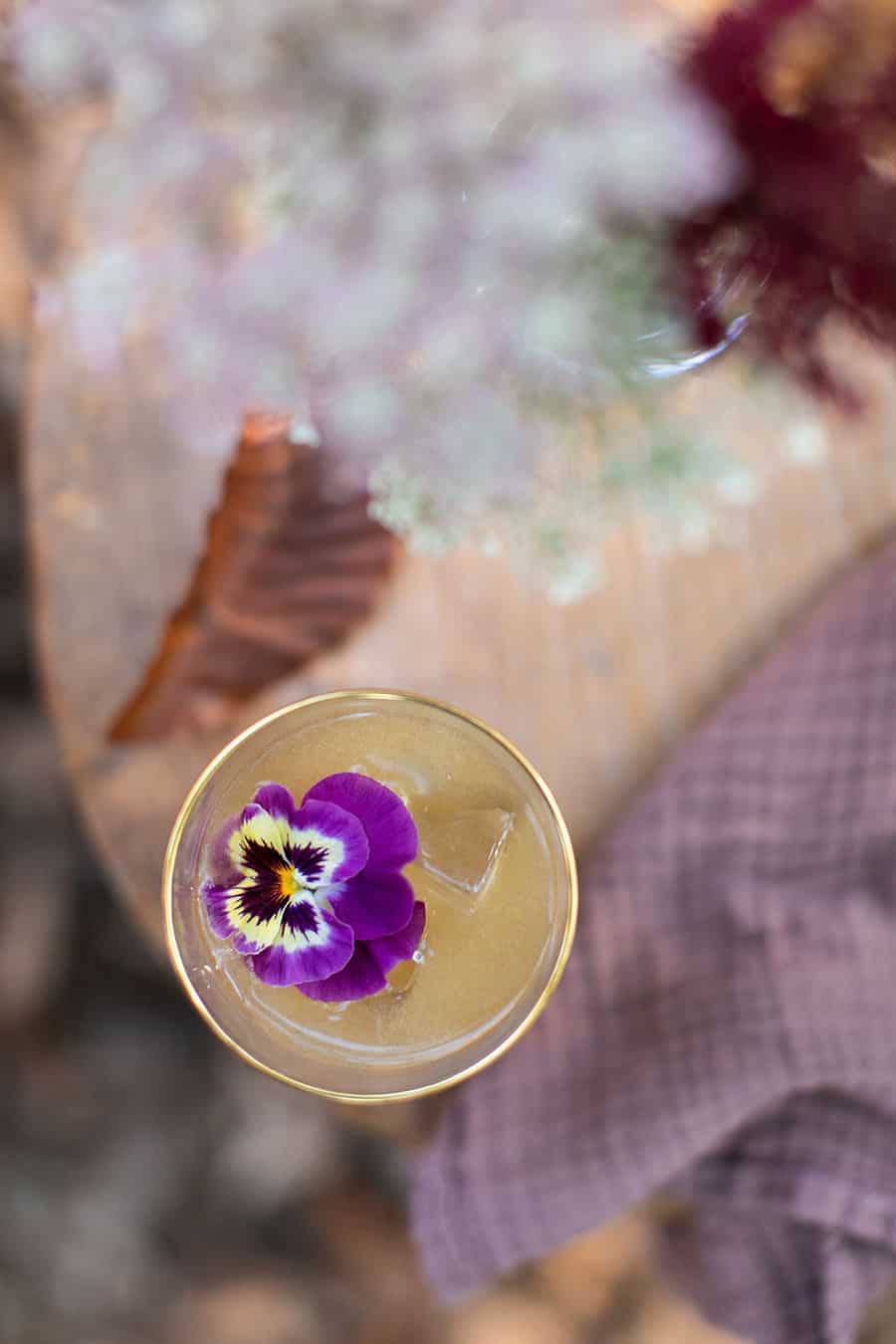 Bourbon cocktail with an edible flower.