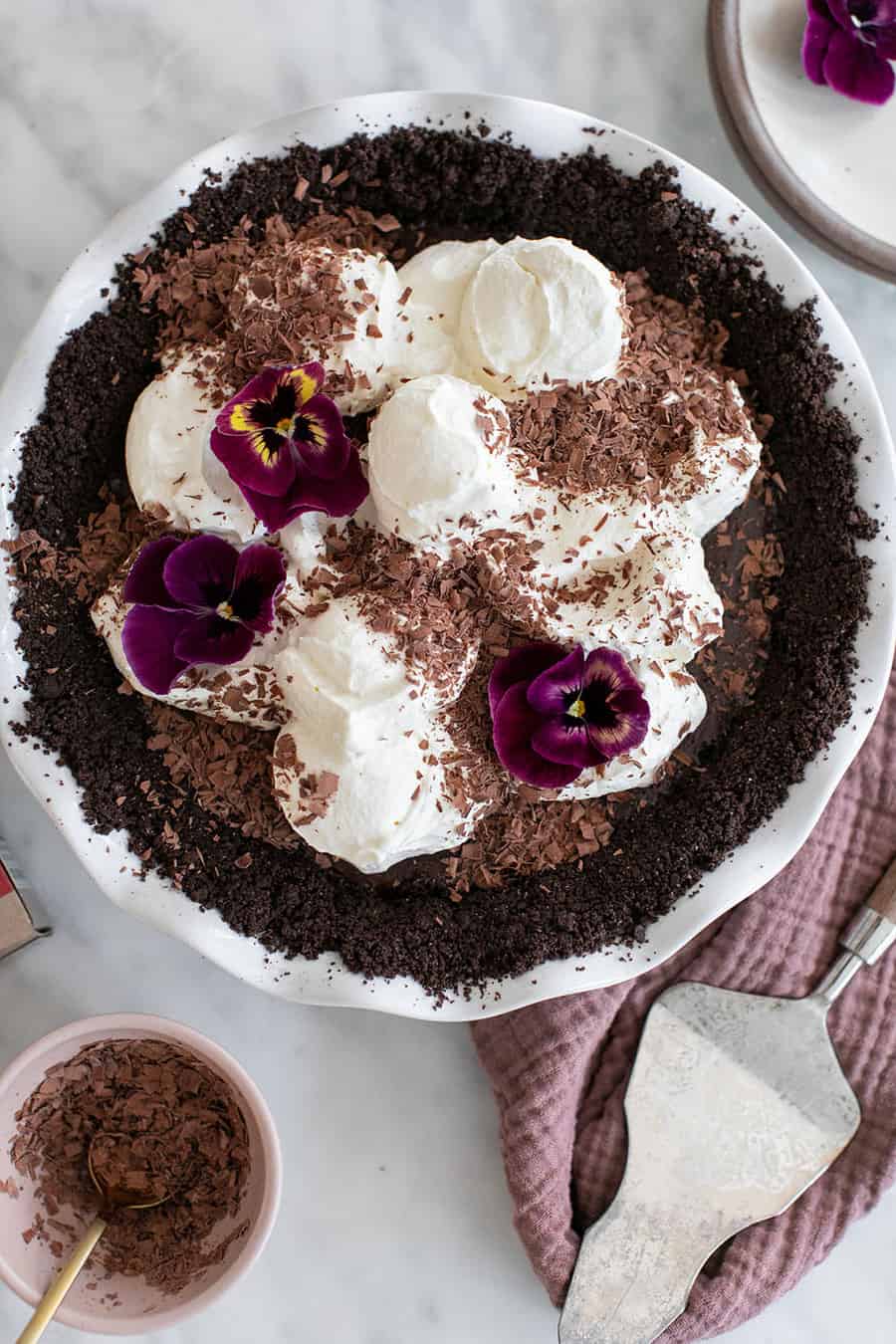 Chocolate pie with whipped cream and edible flowers