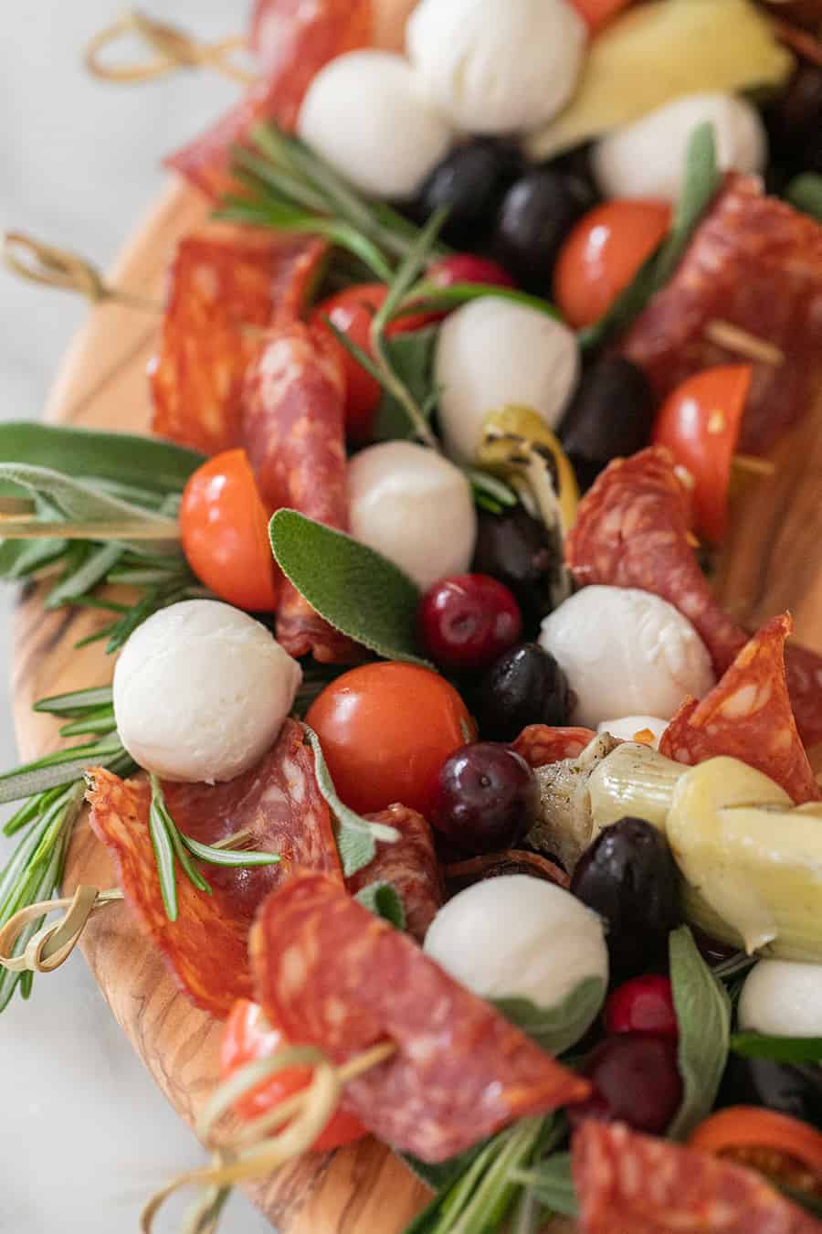 Antipasto skewers with cheese, olive, fresh sage and tomatoes. 