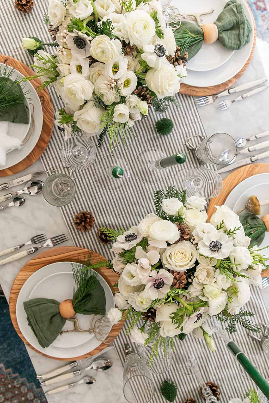 Flowers on a table with a striped table runner.