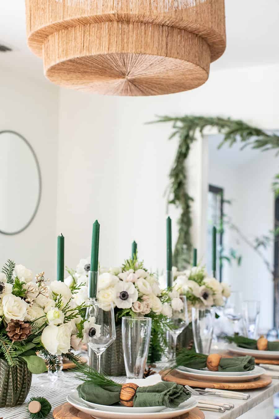 Green and white woodsy Christmas table decorations.