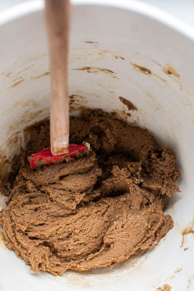 Gingerbread cookie dough creamed in a mixing bowl before chilling.
