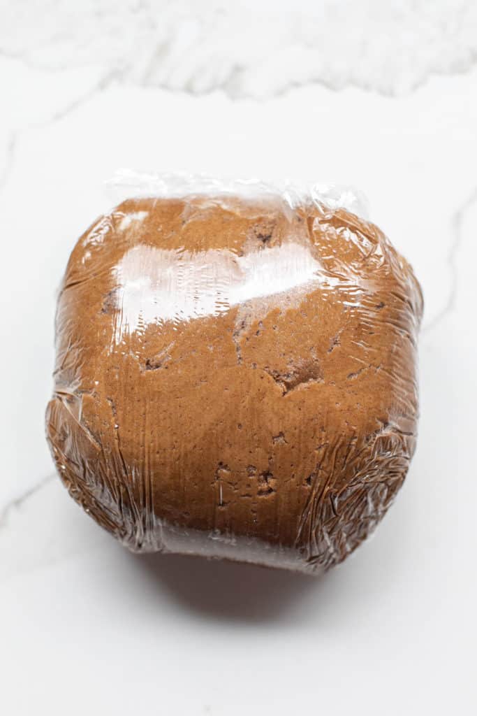 Gingerbread cookie dough wrapped in plastic.