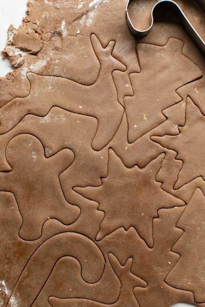 Cutout gingerbread cookie shapes before baking.