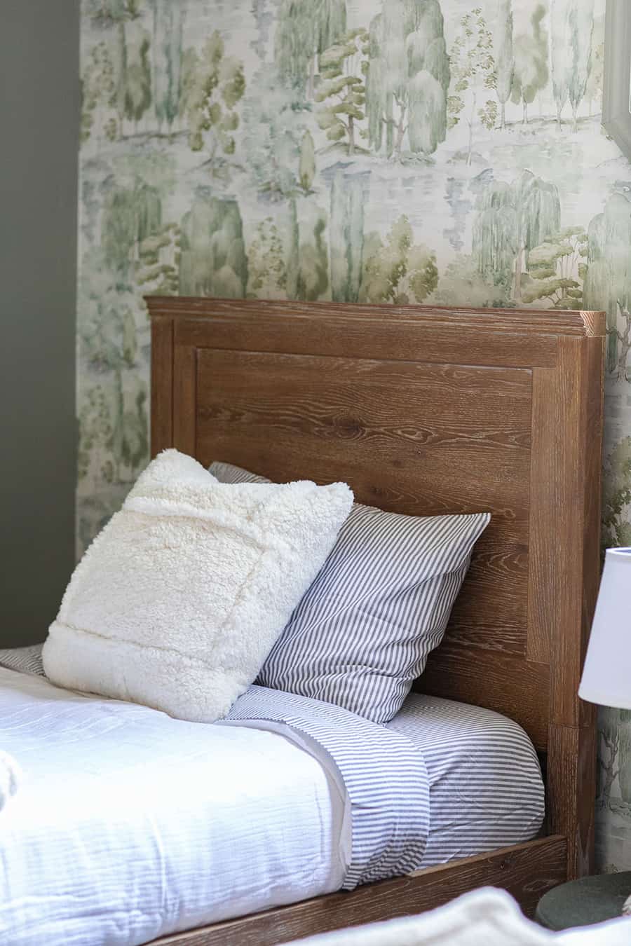 Wooden bed and bedding from Pottery Barn 