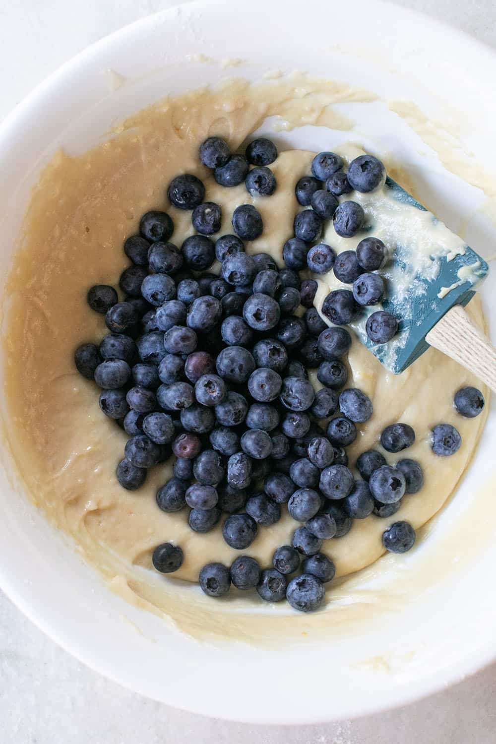 Muffin batter with fresh blueberries. 