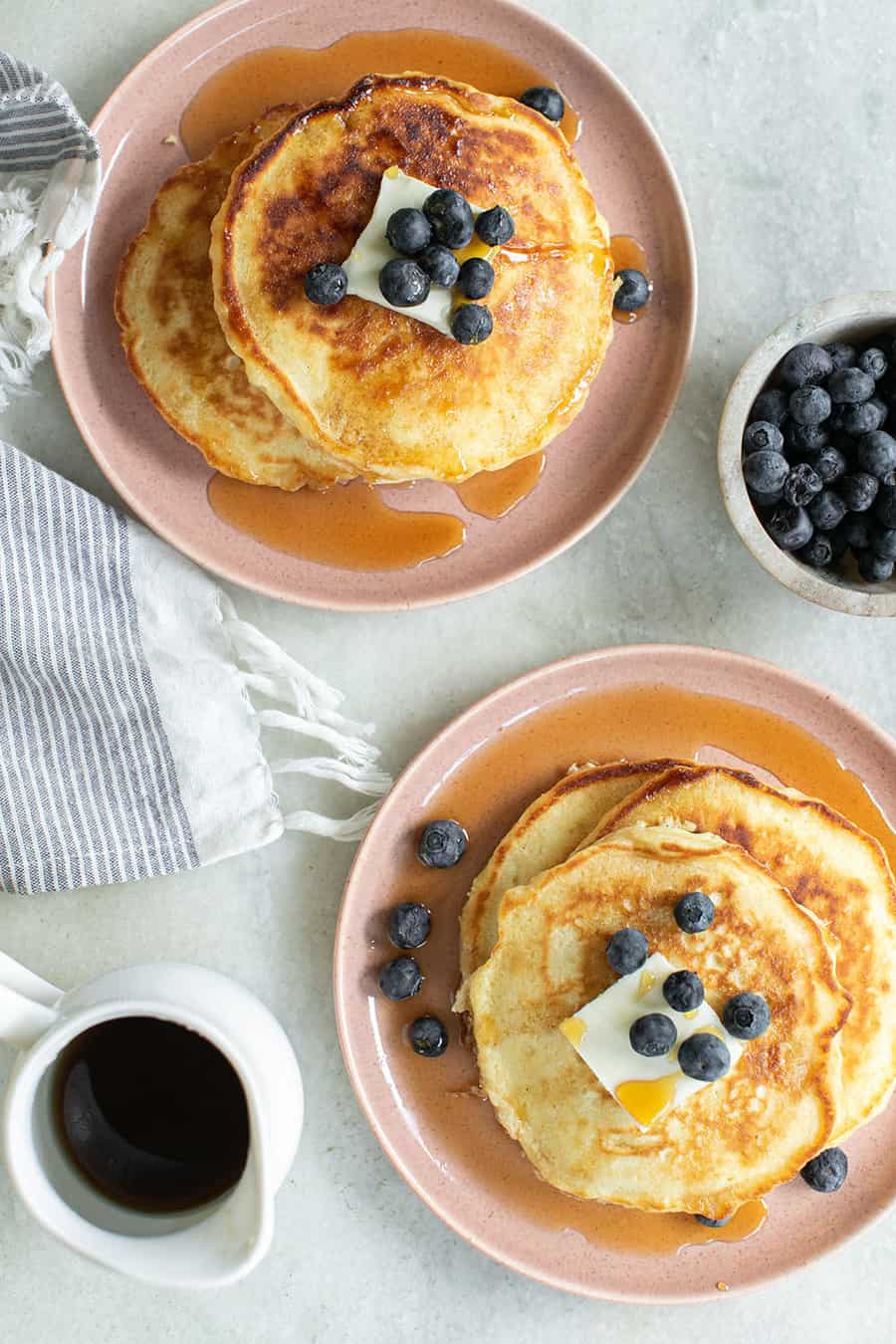 Stack of pancakes on plates.